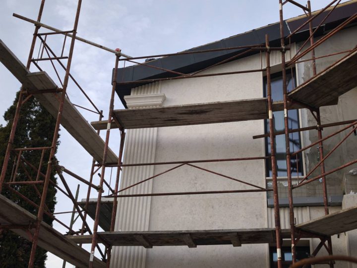 Facade project with scaffolding during installation
